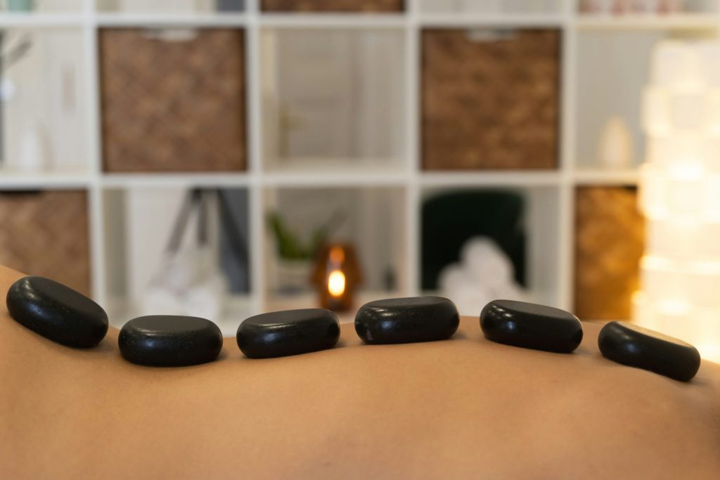 Hot stones rest on a person's back